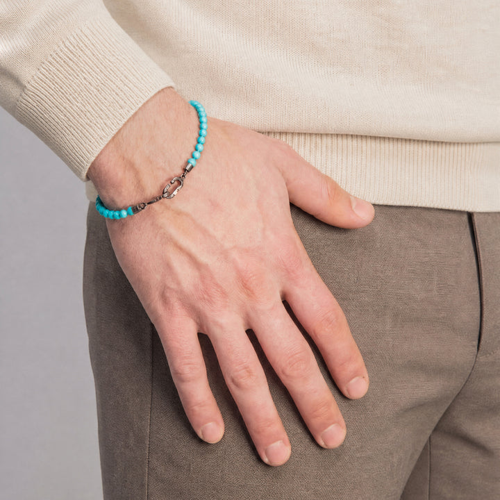 Model wearing the LINK Mini Beads Eternity Bracelet featuring turquoise beads.